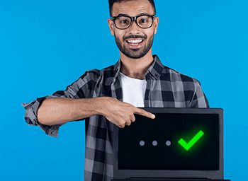 Male in Glasses Smiling Holding Laptop
