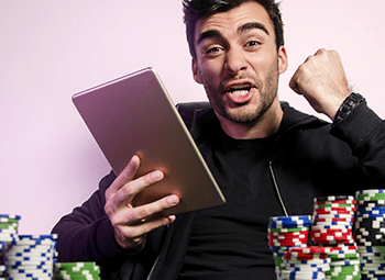 Young Male Holding Ipad Cheering